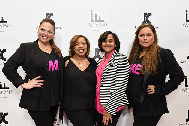 A group of women pose for a photo at the Empowering Young Women event.